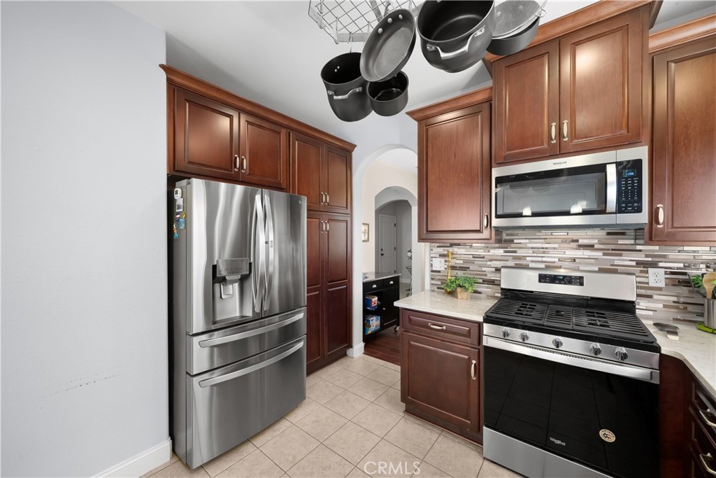 731 Voyager Road Lompoc, CA 93436 - Photo 15 of 57 a kitchen with stainless steel appliances granite countertop a refrigerator microwave and stove