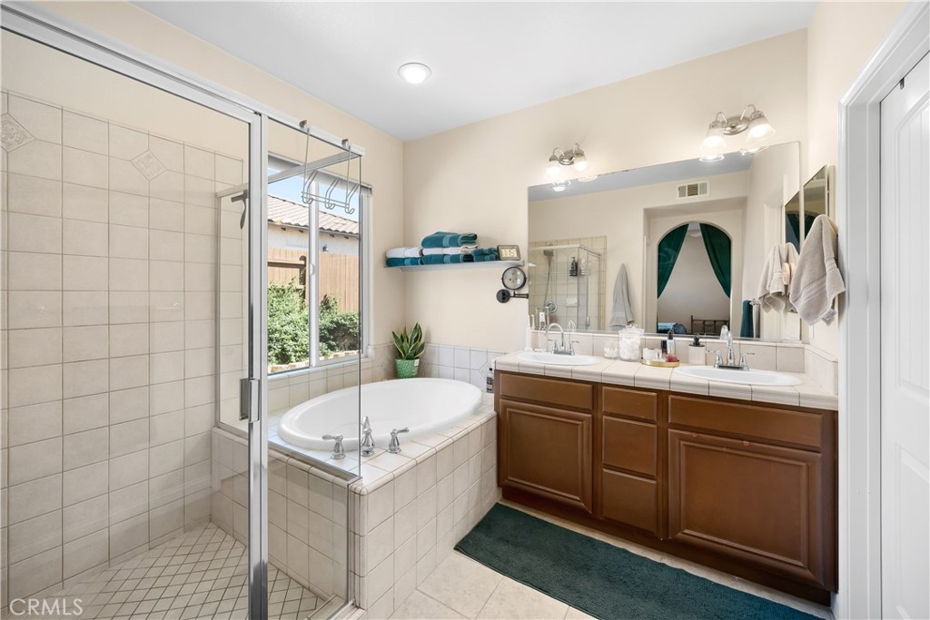 731 Voyager Road Lompoc, CA 93436 - Photo 25 of 57 a bathroom with a double vanity sink mirror and bathtub