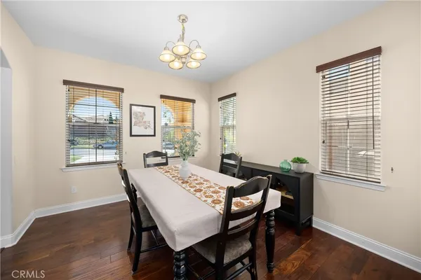 a view of a dining room with furniture and chandelier