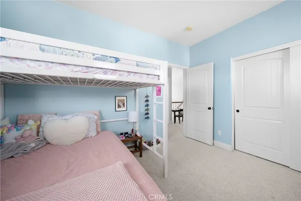 a bedroom with a bed and windows