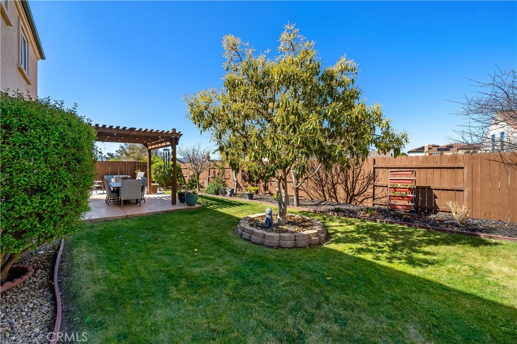 731 Voyager Road Lompoc, CA 93436 - Photo 40 of 57 a view of a backyard with table and chairs and potted plants