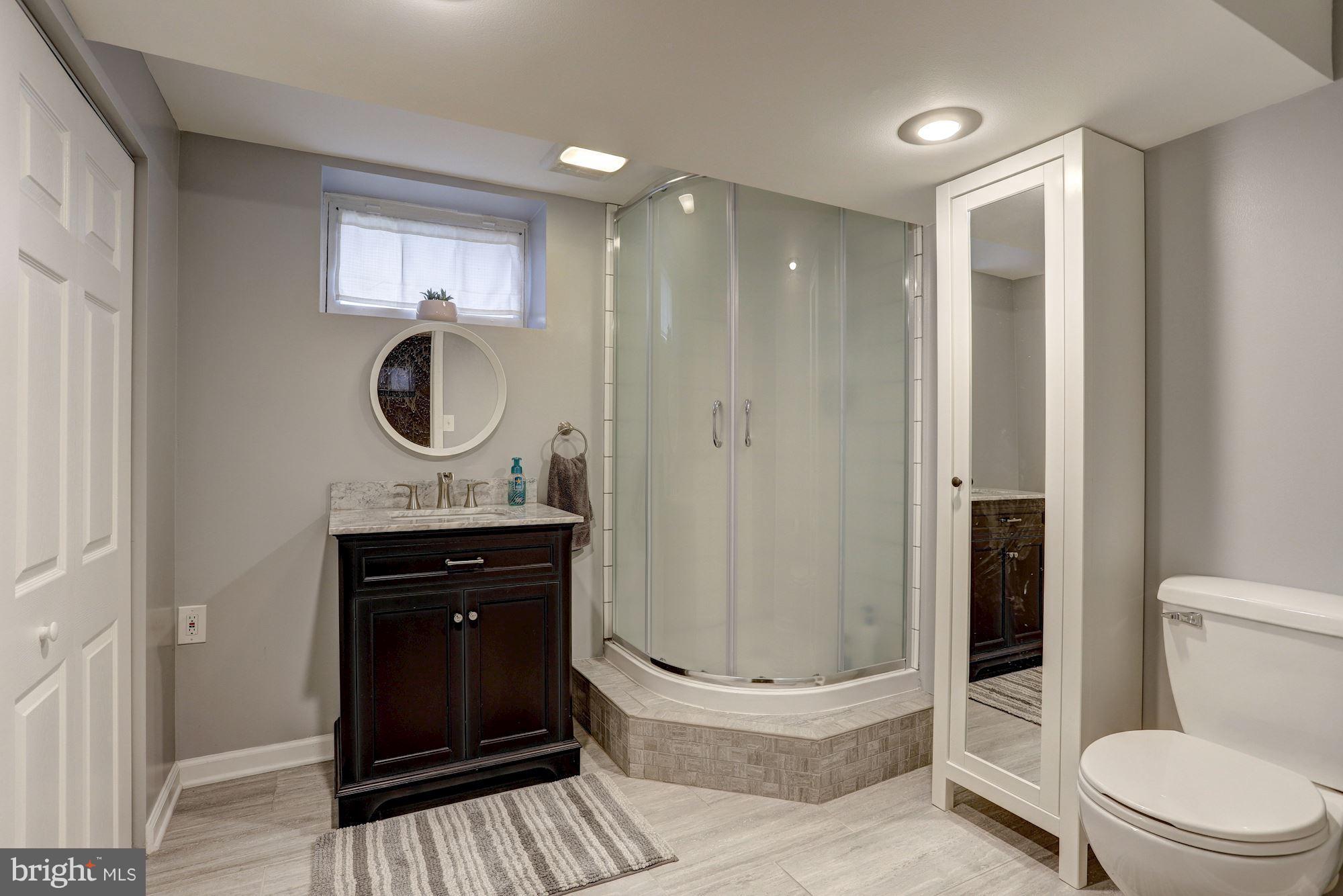 2503 Wendover Road Baltimore, MD 21234 - Photo 19 of 22 a bathroom with a sink a toilet and shower
