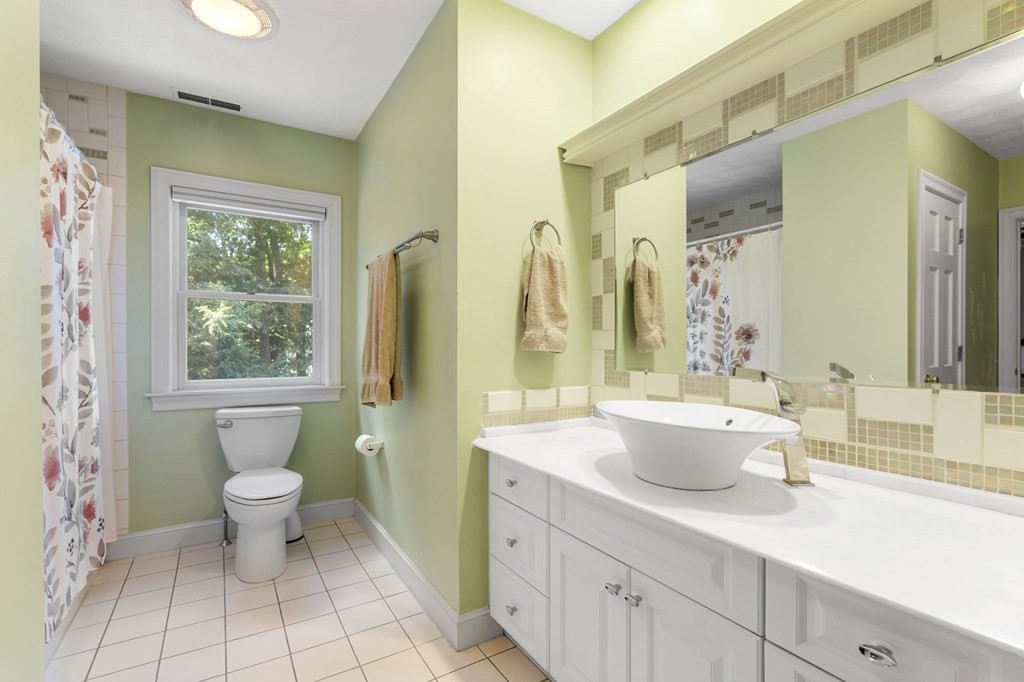 24 Whitney Road Boxford, MA 01921 - Photo 12 of 42 a bathroom with a granite countertop sink a toilet a mirror and shower