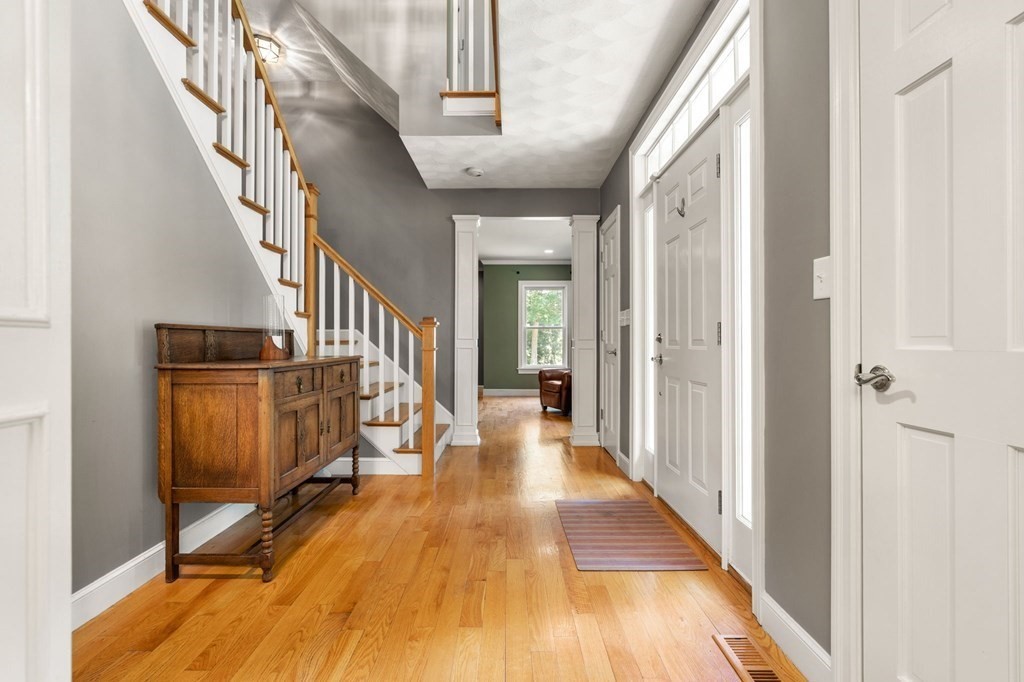 24 Whitney Road Boxford, MA 01921 - Photo 31 of 42 a view of a hallway with wooden floor and staircase