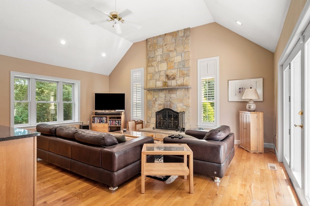 24 Whitney Road Boxford, MA 01921 - Photo 32 of 42 a living room with furniture fireplace and a flat screen tv