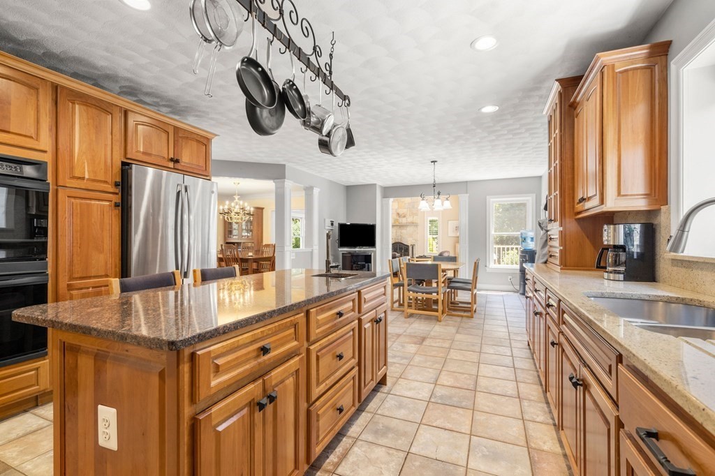 24 Whitney Road Boxford, MA 01921 - Photo 7 of 42 a kitchen with stainless steel appliances granite countertop a sink and cabinets