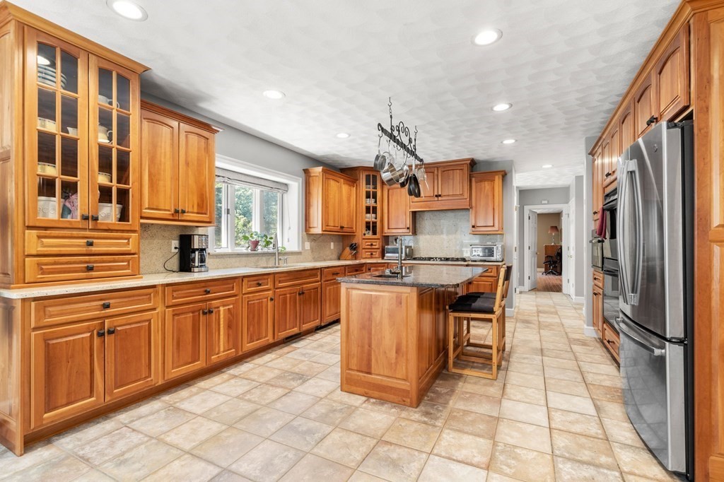 24 Whitney Road Boxford, MA 01921 - Photo 9 of 42 a kitchen with stainless steel appliances granite countertop a refrigerator and a sink