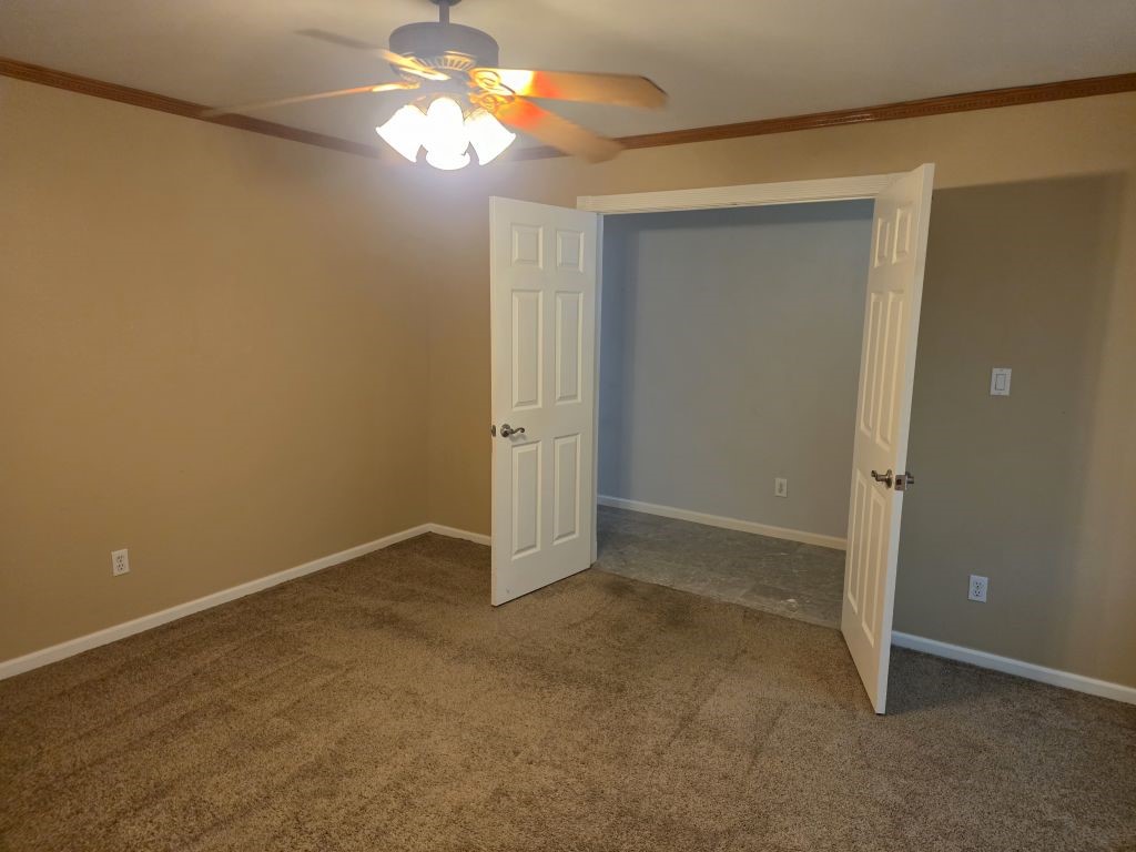 13600 Farm To Market Road 1314 Conroe, TX 77302 - Photo 19 of 26 an empty room with windows and fan