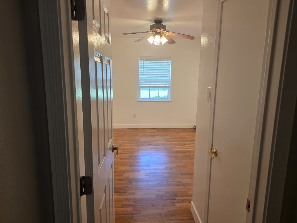 13600 Farm To Market Road 1314 Conroe, TX 77302 - Photo 21 of 26 a view of a hallway with a window and wooden floor