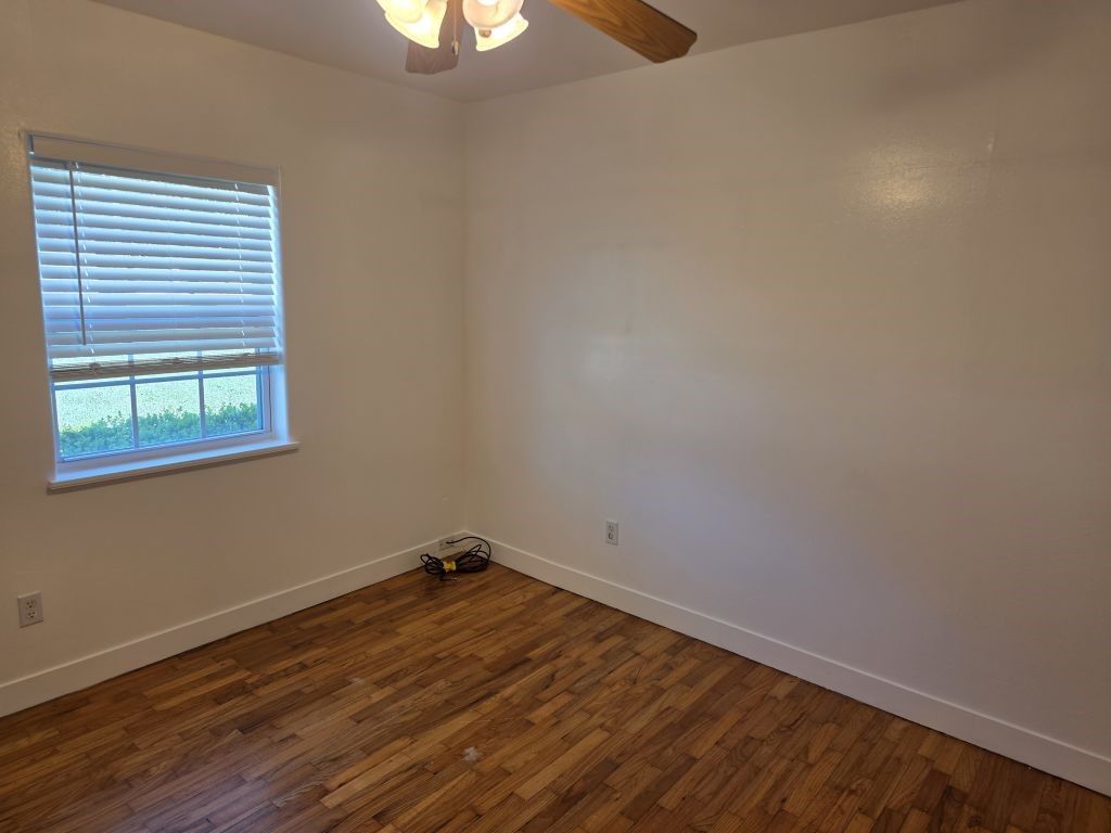13600 Farm To Market Road 1314 Conroe, TX 77302 - Photo 23 of 26 a room with a window and wooden floor
