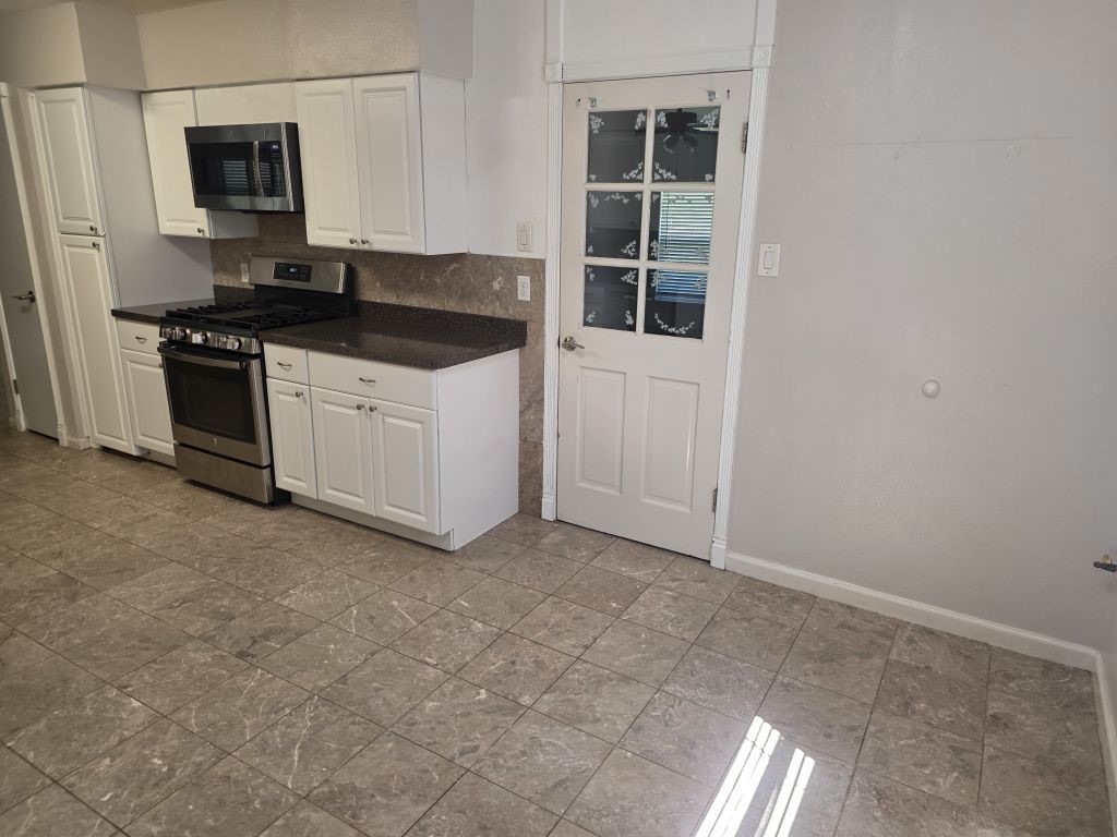 13600 Farm To Market Road 1314 Conroe, TX 77302 - Photo 6 of 26 a kitchen with a sink and cabinets