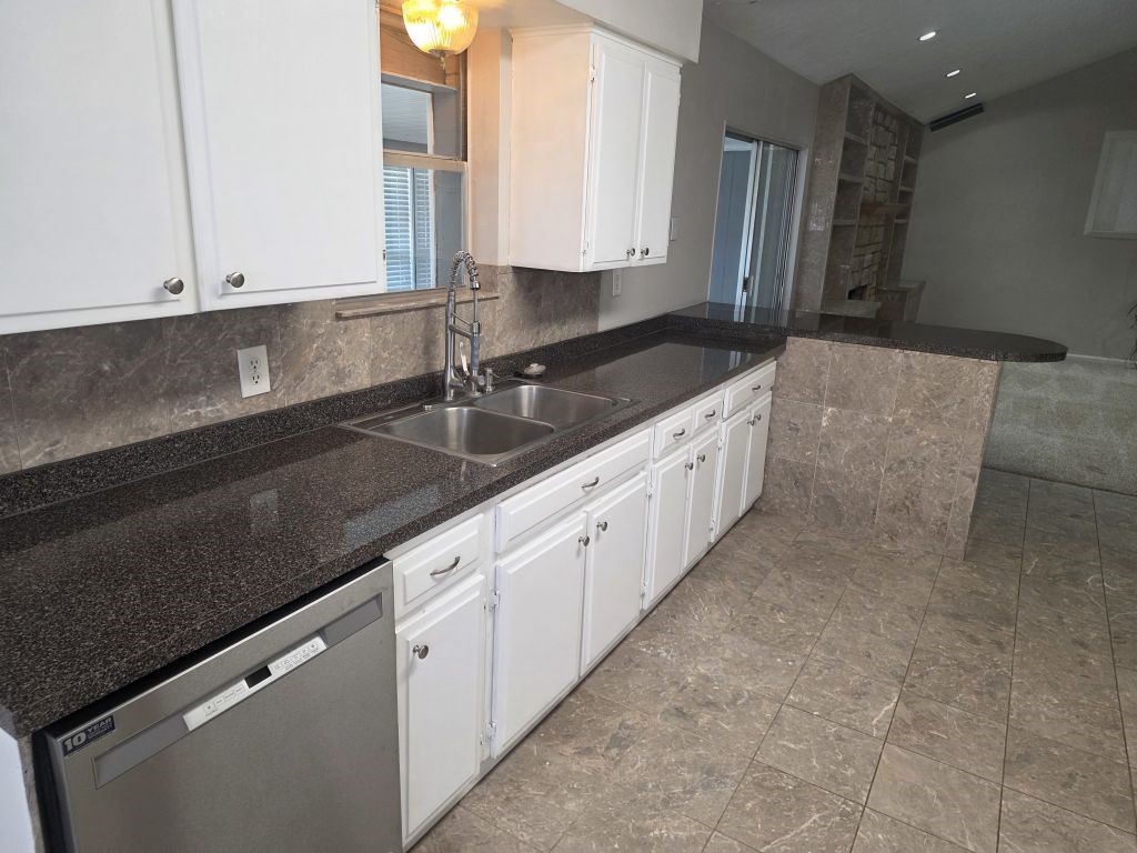13600 Farm To Market Road 1314 Conroe, TX 77302 - Photo 8 of 26 a large kitchen with granite countertop a sink and a stove