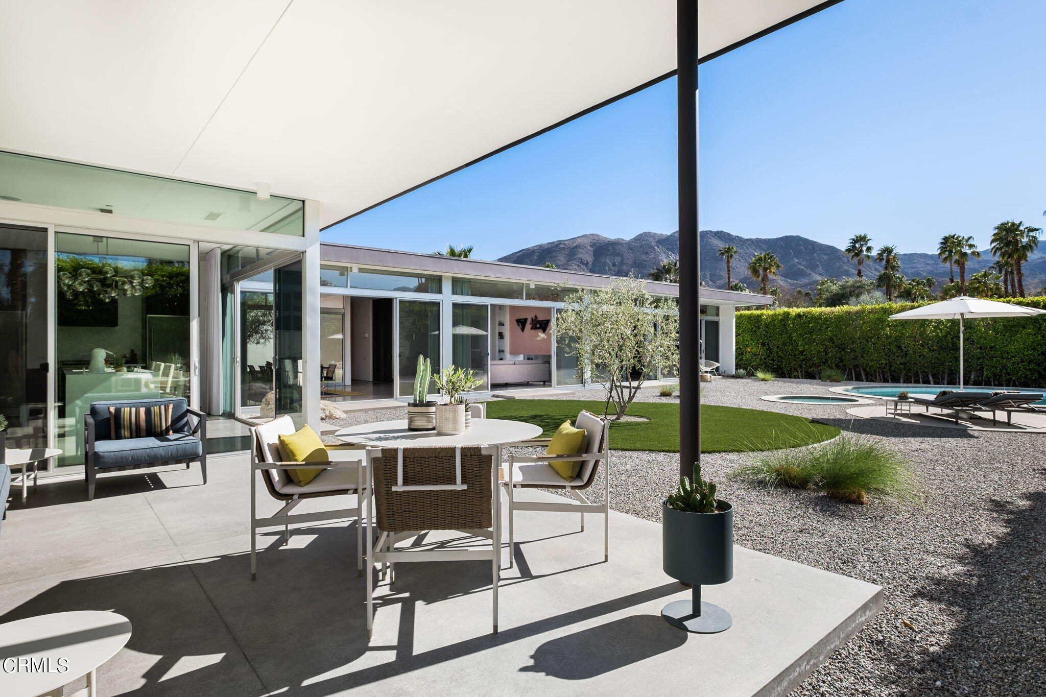 71466 San Gorgonio Road Rancho Mirage, CA 92270 - Photo 12 of 31 a view of a patio with a dining table chairs and a fire pit