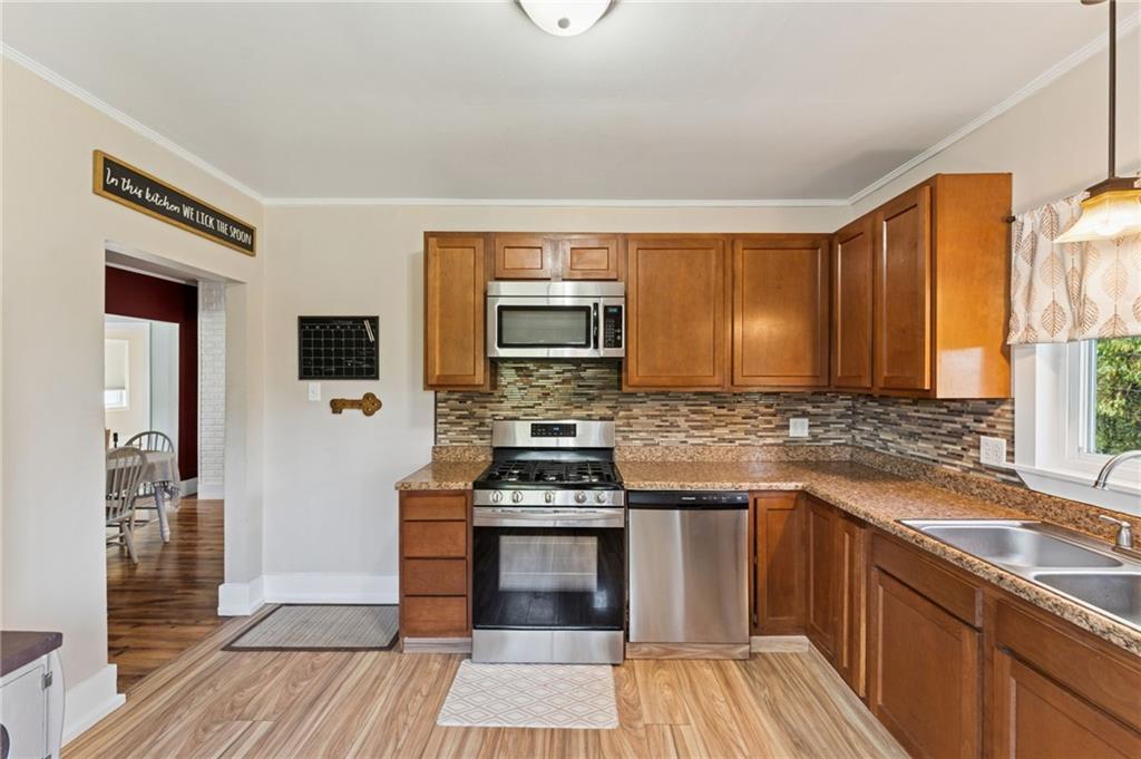 90 Shrader Lane Irwin, PA 15642 - Photo 11 of 39 a kitchen with stainless steel appliances a stove sink and cabinets