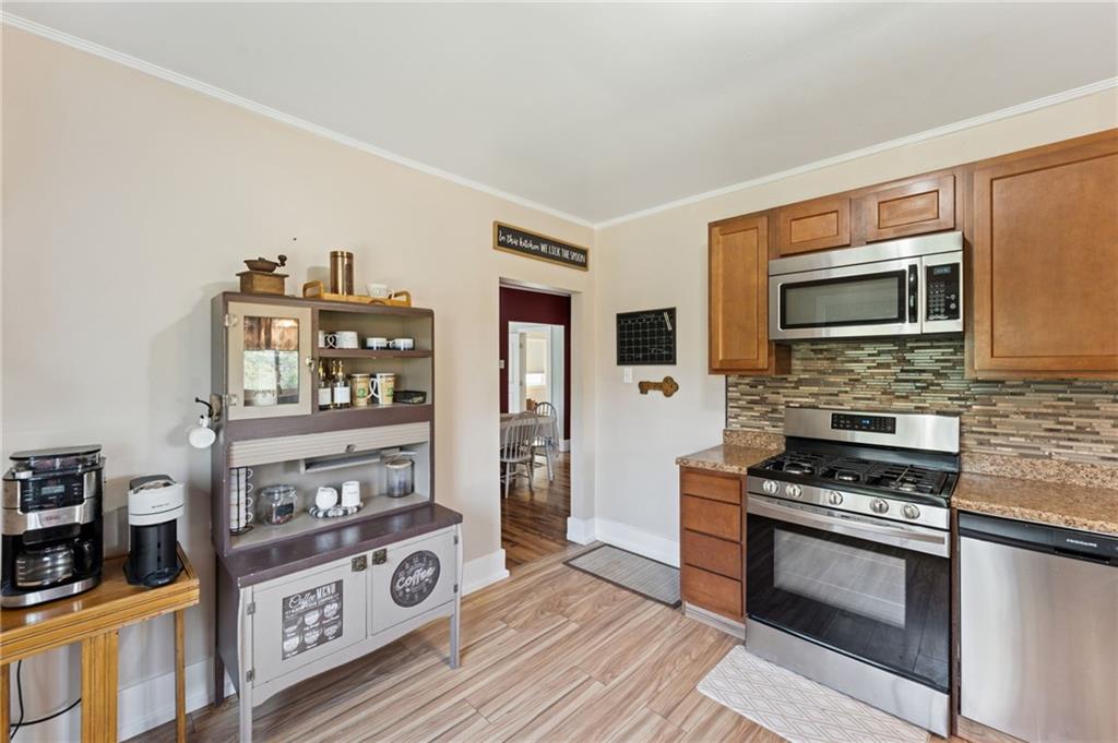 90 Shrader Lane Irwin, PA 15642 - Photo 12 of 39 a kitchen with stainless steel appliances a stove and a microwave