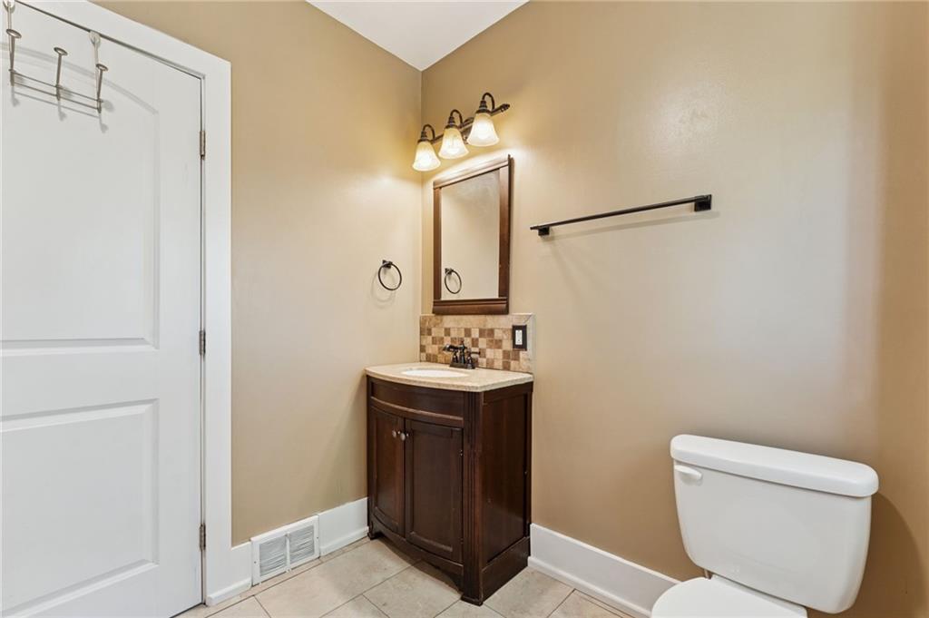 90 Shrader Lane Irwin, PA 15642 - Photo 16 of 39 a bathroom with a sink a toilet and mirror