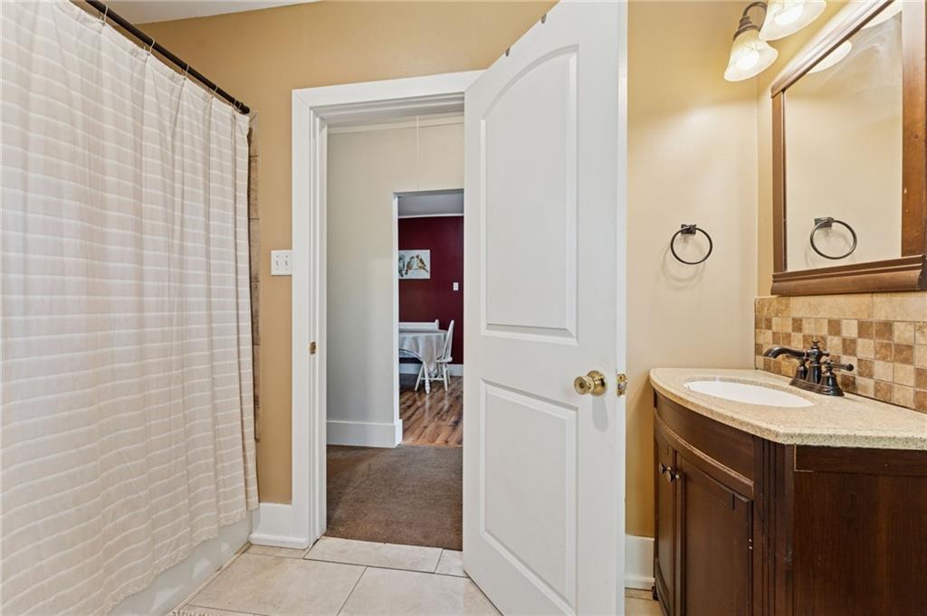 90 Shrader Lane Irwin, PA 15642 - Photo 17 of 39 a bathroom with a sink a mirror and a shower