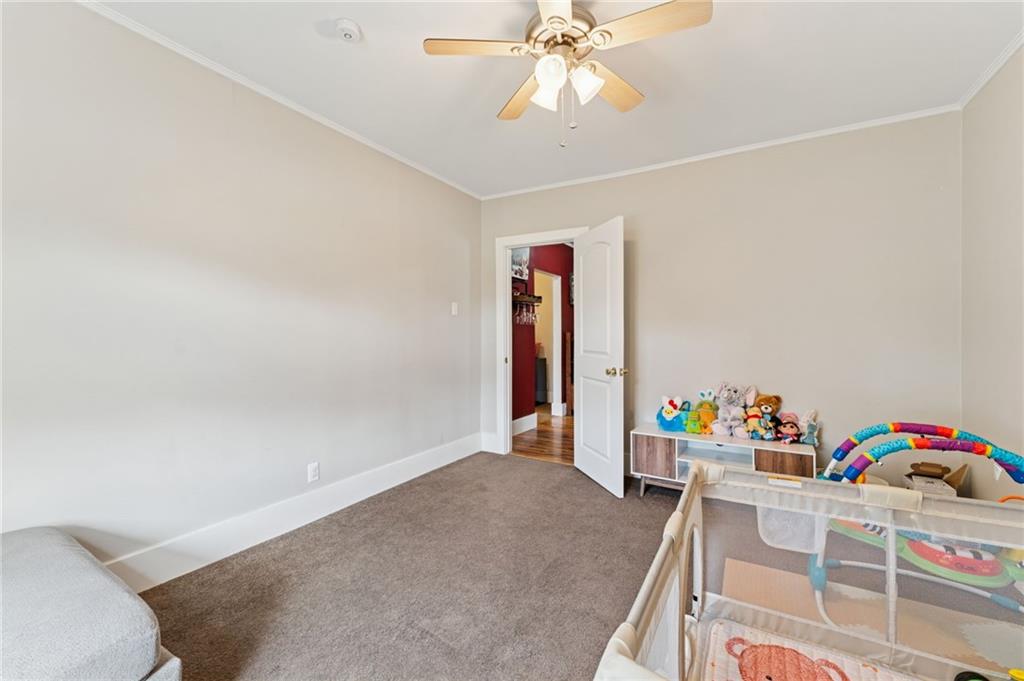 90 Shrader Lane Irwin, PA 15642 - Photo 19 of 39 a bedroom with a bed and a chandelier