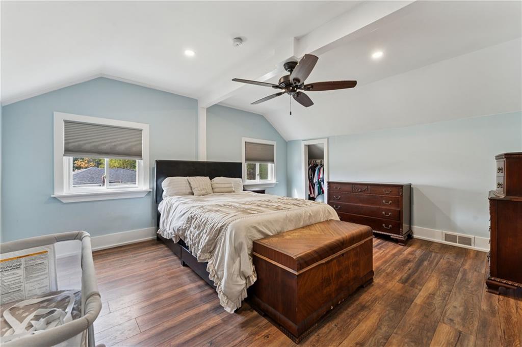 90 Shrader Lane Irwin, PA 15642 - Photo 28 of 39 a spacious bedroom with a bed and a chandelier