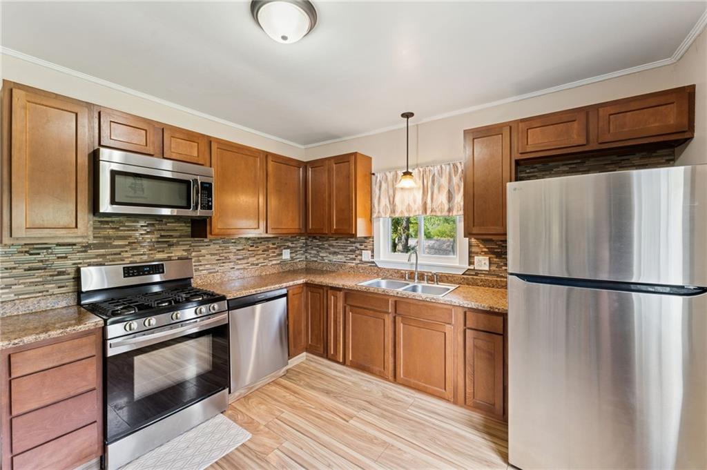 90 Shrader Lane Irwin, PA 15642 - Photo 10 of 39 a kitchen with stainless steel appliances a refrigerator sink and microwave