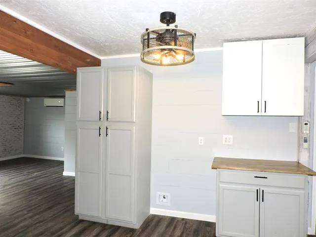 a view of a closet area with wooden floor