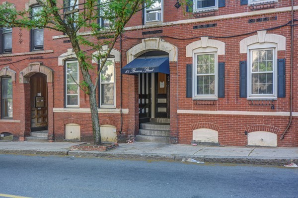 64 Beacon Street Chelsea, MA 02150 - Photo 2 of 10 a front view of a brick house with a outdoor space