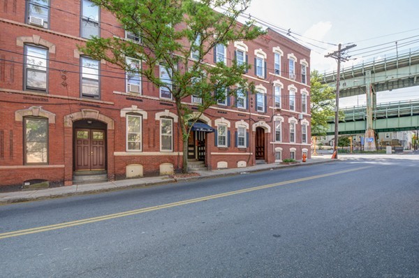 64 Beacon Street Chelsea, MA 02150 - Photo 3 of 10 a couple of cars parked in front of brick building