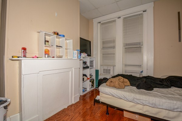 64 Beacon Street Chelsea, MA 02150 - Photo 8 of 10 a bedroom with a bed and a flat screen tv