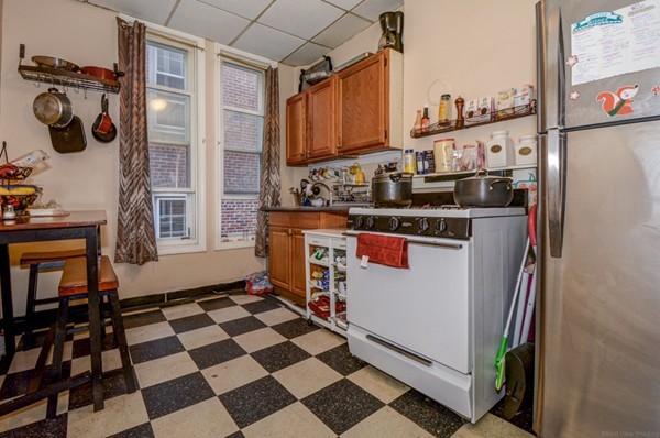 64 Beacon Street Chelsea, MA 02150 - Photo 9 of 10 a kitchen with a stove a sink and a refrigerator