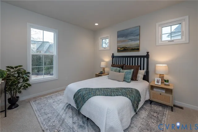 a bedroom with a bed lamp and a potted plant
