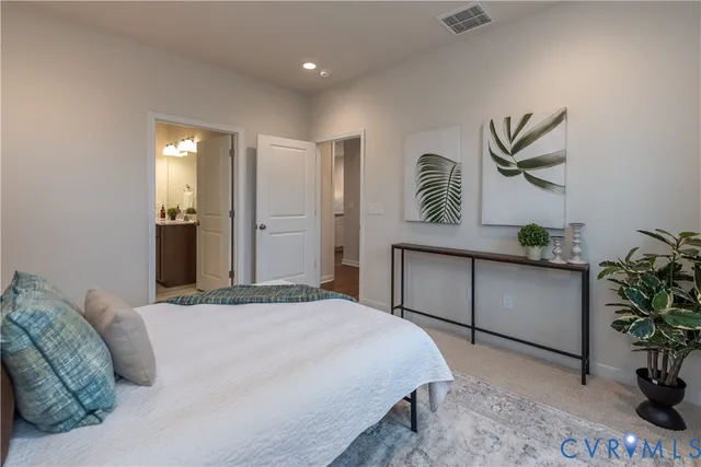 a bedroom with a bed and a potted plant