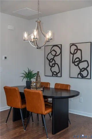 a view of a dining room with furniture and chandelier