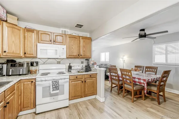 a view of a kitchen with a table and chairs in it
