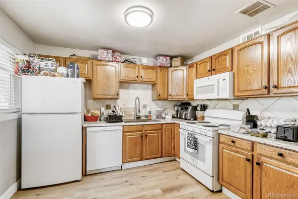 a kitchen with a white cabinets and white appliances