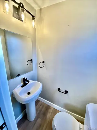 a bathroom with a sink toilet and mirror