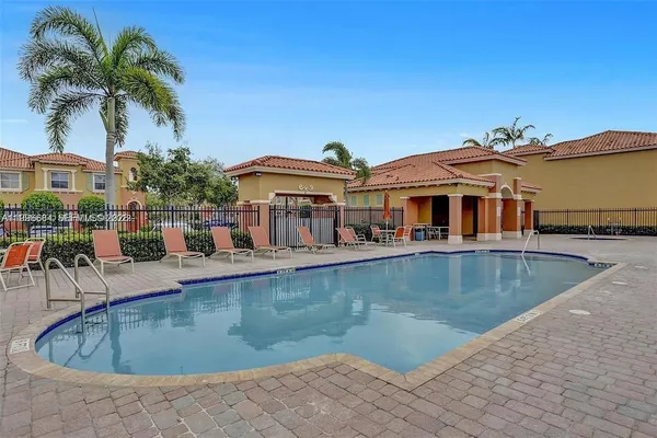a view of a swimming pool with outdoor seating