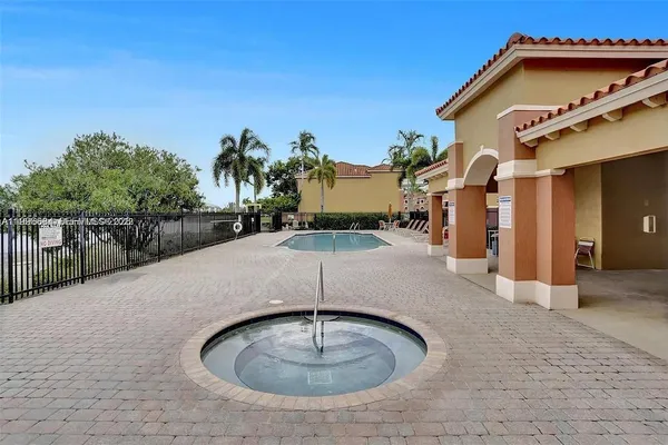 a swimming pool with a yard in front of it