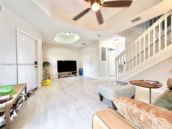 a living room with furniture and a flat screen tv