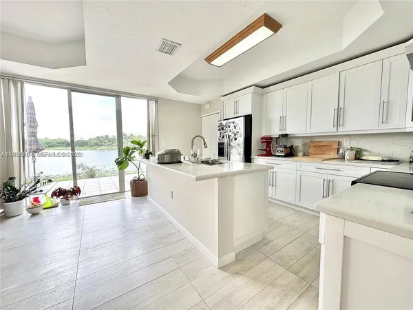 a kitchen with a sink cabinets and counter top space