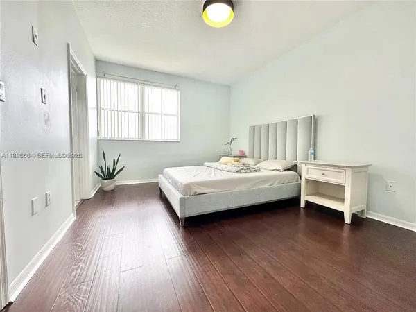 a bedroom with bed and window