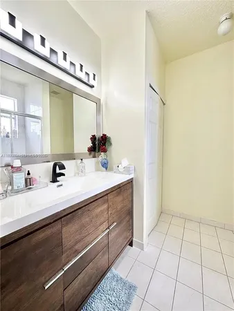 a bathroom with a sink a mirror and a shower