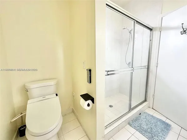 a white toilet sitting next to a bathroom