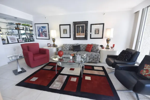 a living room with furniture rug and window