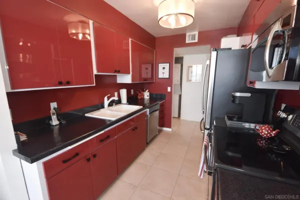 a kitchen with stainless steel appliances a sink and a refrigerator