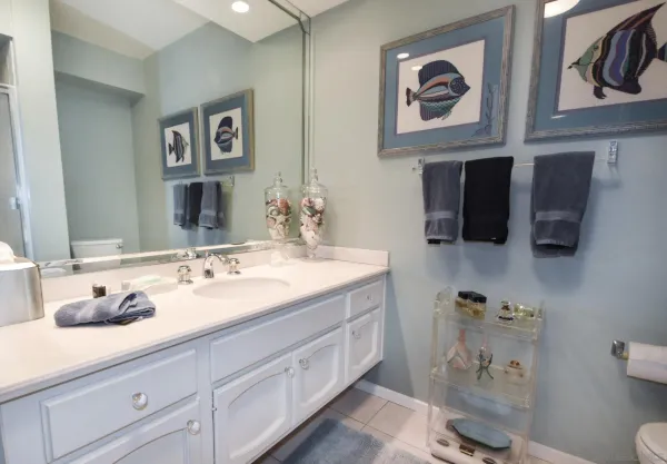 a bathroom with a granite countertop sink mirror and toilet