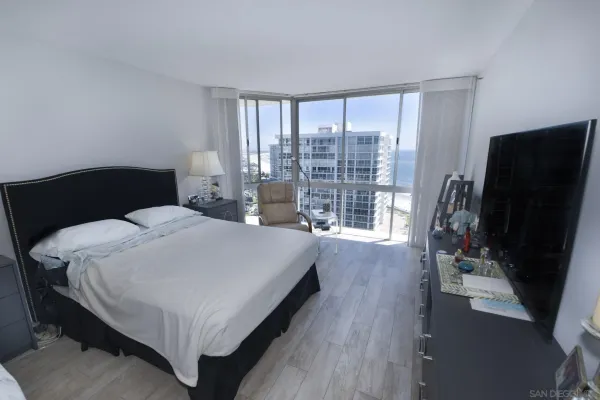 a bedroom with a bed window and wooden floor