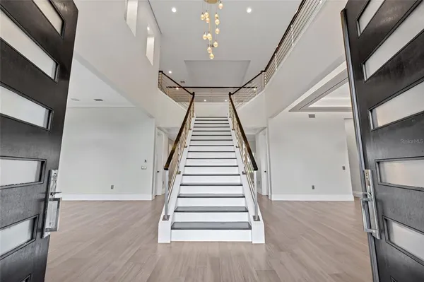 a kitchen with stainless steel appliances granite countertop a sink stove a refrigerator and a oven with wooden floor