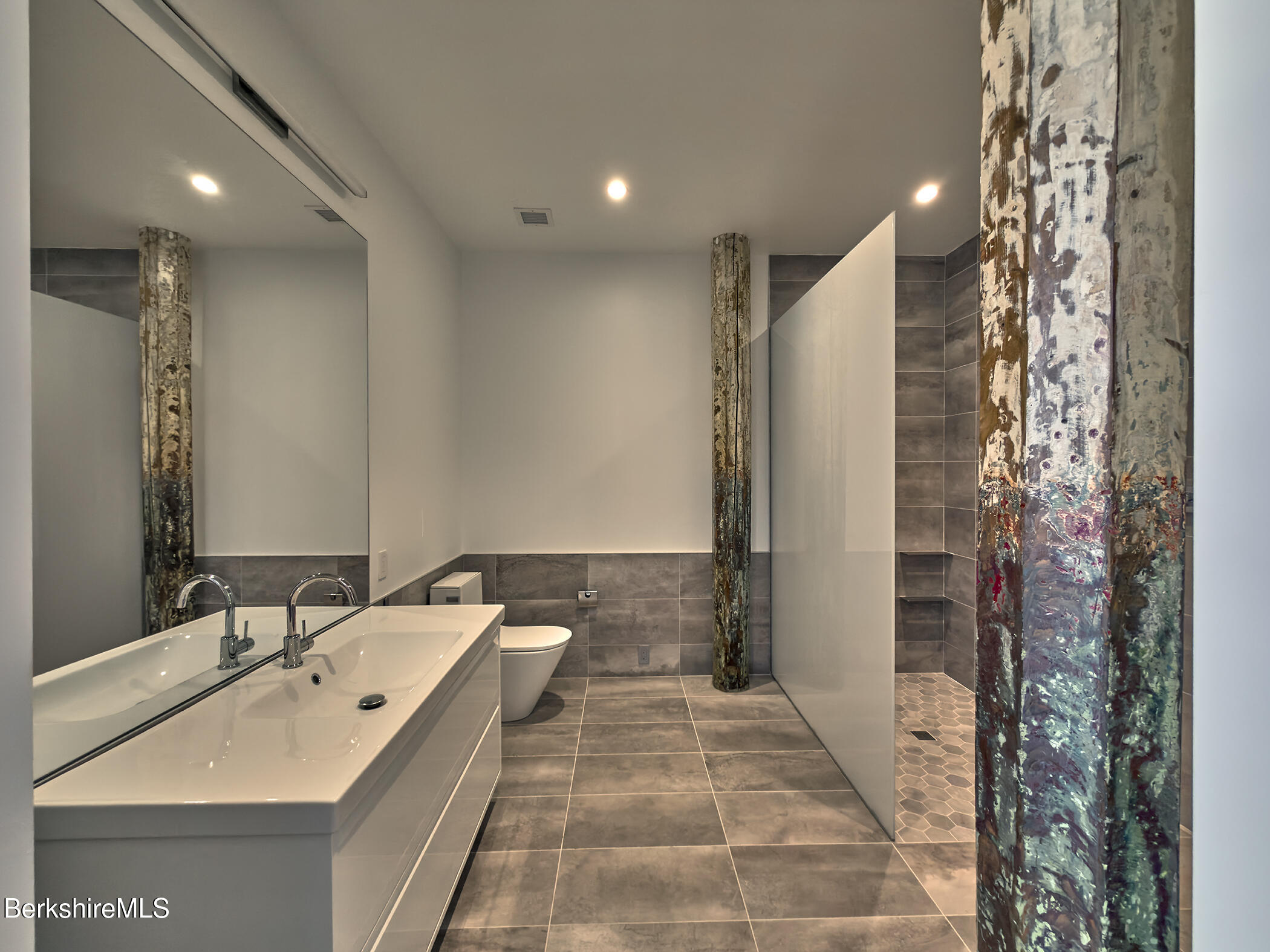 520 State Road, Unit 303 North Adams, MA 01247 - Photo 15 of 16 a bathroom with a double vanity sink and a mirror