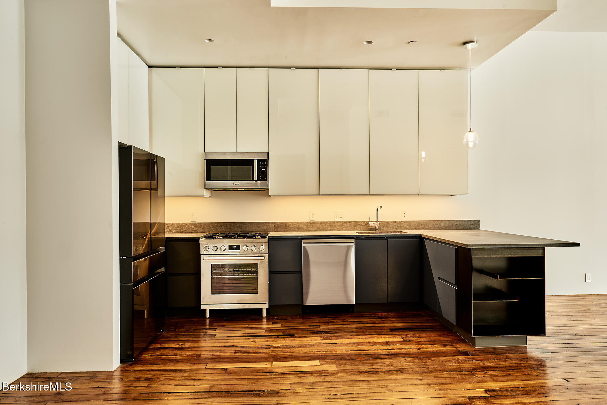 520 State Road, Unit 303 North Adams, MA 01247 - Photo 7 of 16 a kitchen with stainless steel appliances granite countertop a stove a sink and a refrigerator