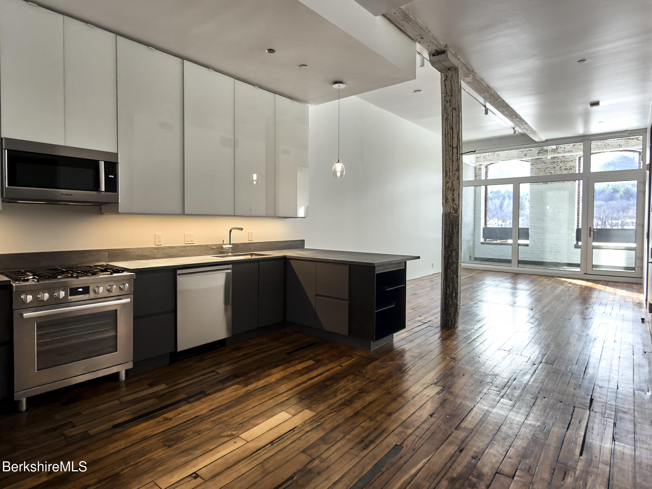520 State Road, Unit 303 North Adams, MA 01247 - Photo 9 of 16 a kitchen with stainless steel appliances granite countertop a sink a stove and a wooden floors